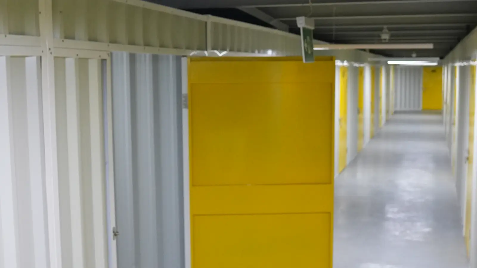 Corridor of full-height storage rooms at Vachi